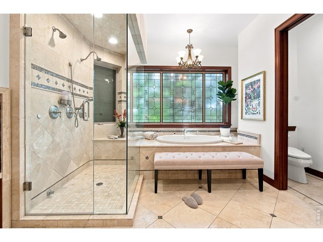 Property Photo 20 Spa-inspired primary bath with oversized walk-in shower, soaking tub and beautiful decorative windows.