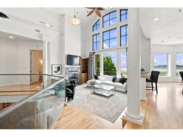 Property Photo 15 Spectacular living room with soaring ceilings, floor-to-ceiling windows, fireplace and breathtaking reservoir views.