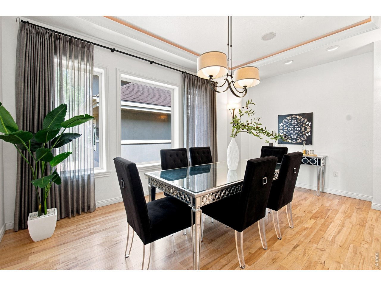 Property Photo 16 Elegant formal dining room with hardwood floors, tray ceiling and sophisticated lighting.