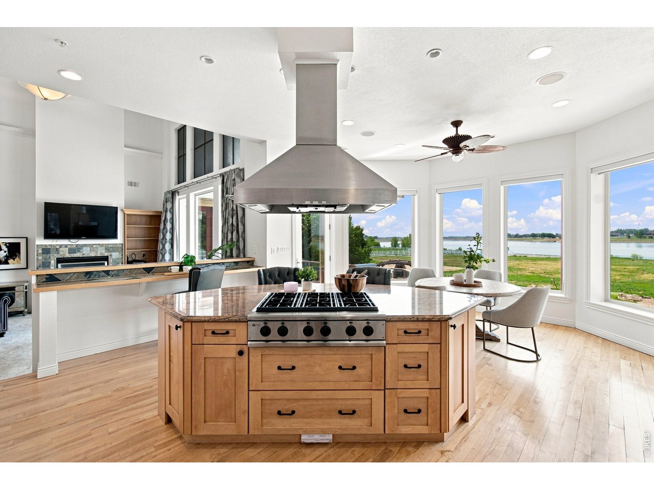 Property Photo 11 Spacious kitchen with large center island, professional-style cooktop and an abundance of natural light and reservoir views.