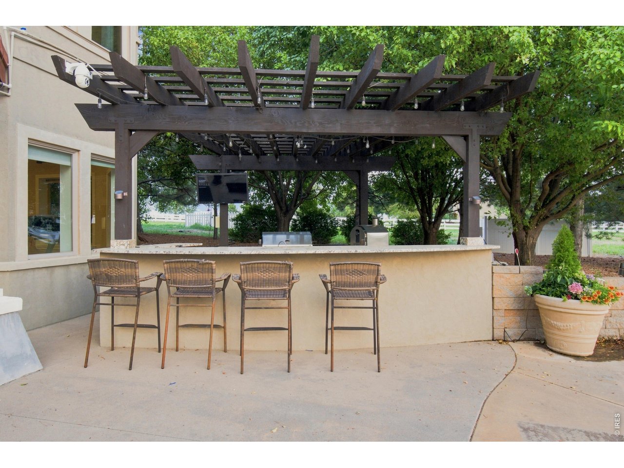 Property Photo 44 Outdoor Kitchen & Entertainment Bar Covered outdoor kitchen and bar with pizza oven, TV and ample seating perfect for outdoor entertaining.