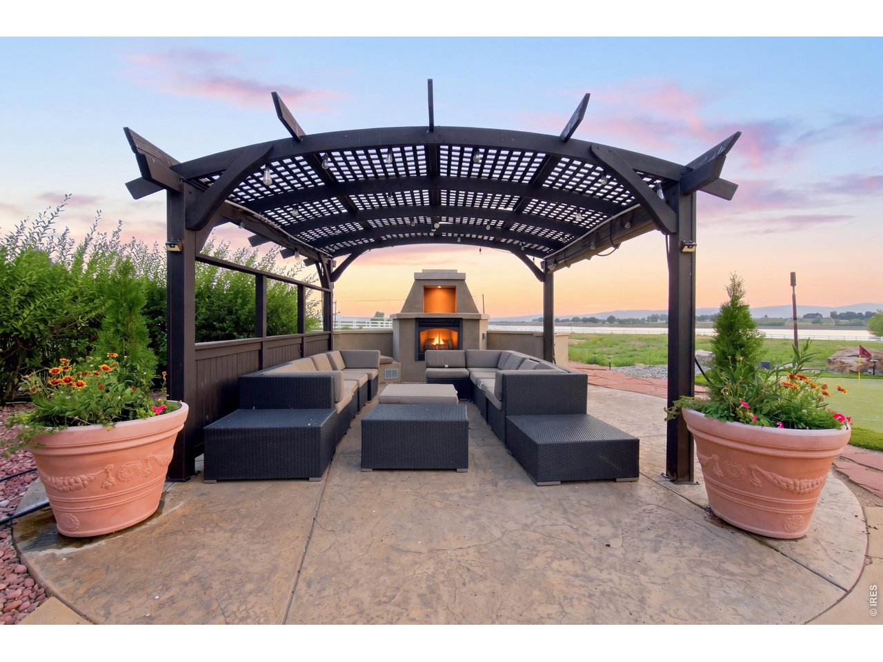 Property Photo 47 Pergola, outdoor living area with fireplace, generous seating and reservoir views.
