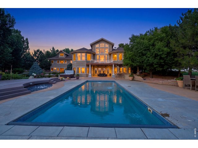 Property Photo 2 Stunning twilight view of the pool and beautifully illuminated rear of the home.