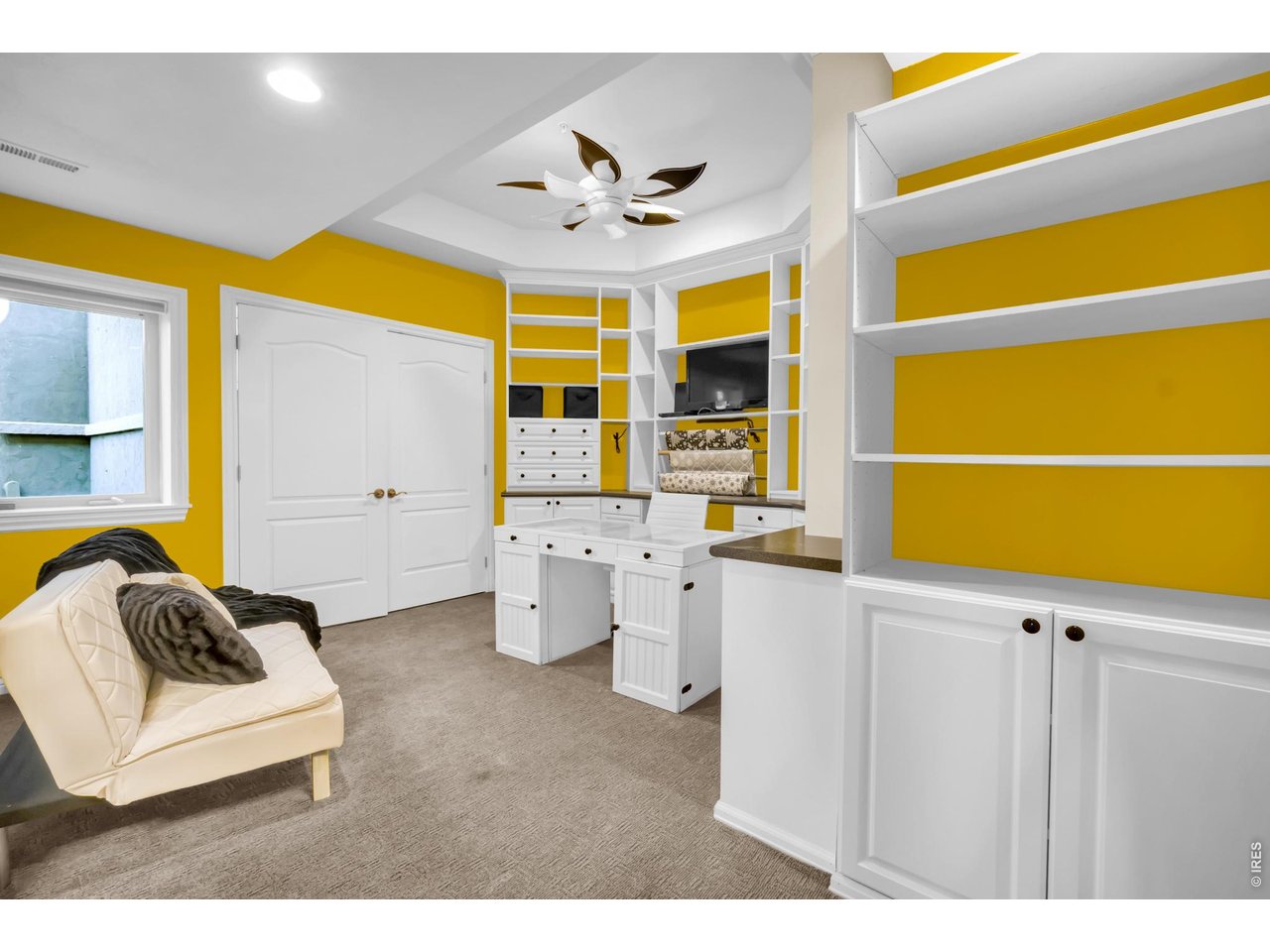 Property Photo 33 Versatile bedroom or private home office featuring extensive custom built-ins and workspace.
