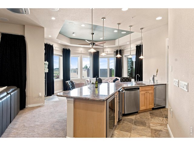 Property Photo 28 Expansive lower-level entertaining area with granite wet bar, multiple beverage appliances and abundant seating