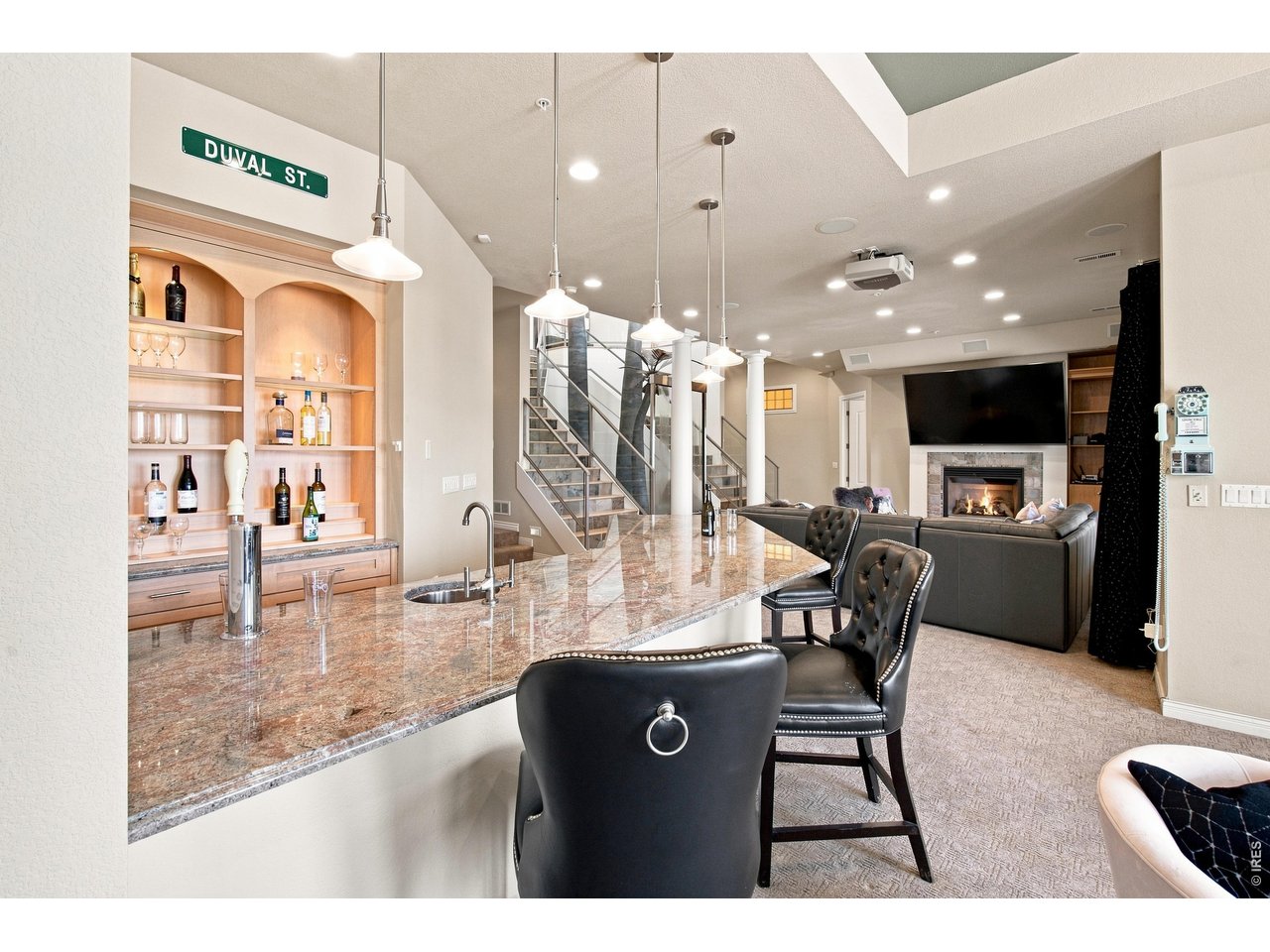 Property Photo 29 Entertainer's dream an impressive full bar opens to the spacious lower-level family room.