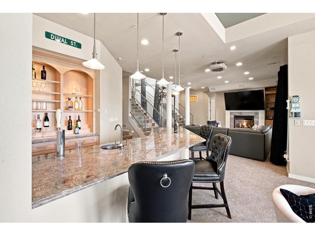 Property Photo 29 Entertainer's dream an impressive full bar opens to the spacious lower-level family room.
