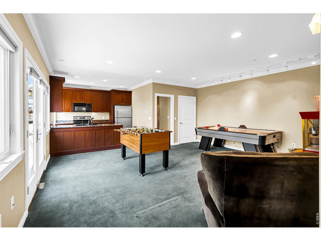 Property Photo 37 Spacious bonus room ideal for a home office, game room or additional living space, complete with kitchenette and abundant natural light.