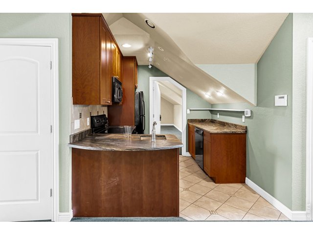 Property Photo 39 Private loft guest quarters feature a kitchenette with refrigerator, range, microwave, sink, dishwasher and cabinetry, conveniently adjoining the sleeping/living area.