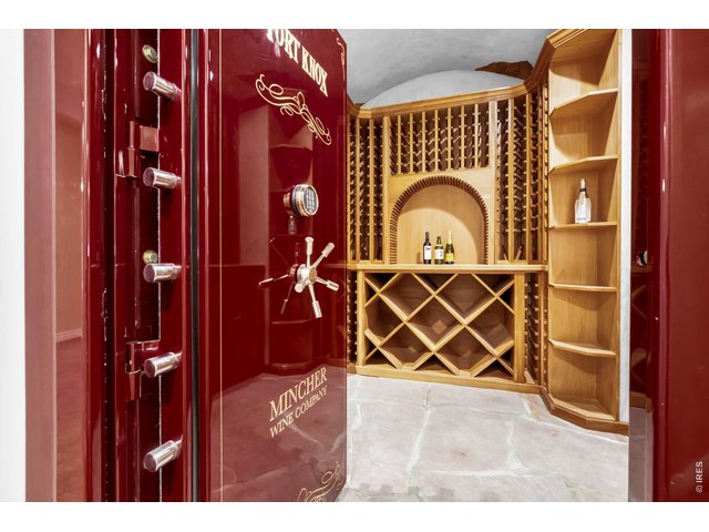Property Photo 35 Custom wine cellar with extensive built-in bottle storage, display shelving and cabinetry.