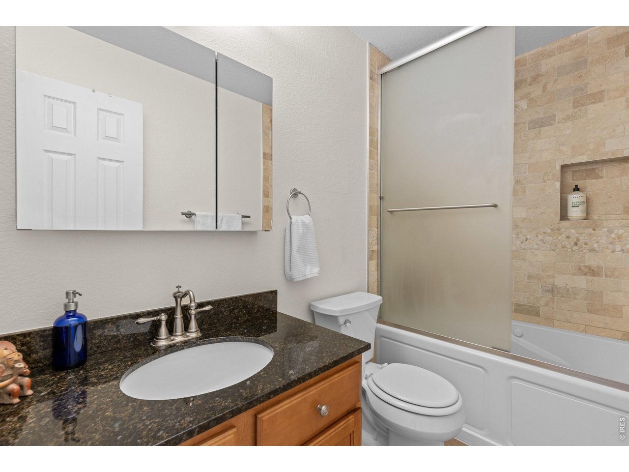 Property Photo 30 Upper level hall bath with Italian travertine tile & a 21" deep jetted soaking tub
