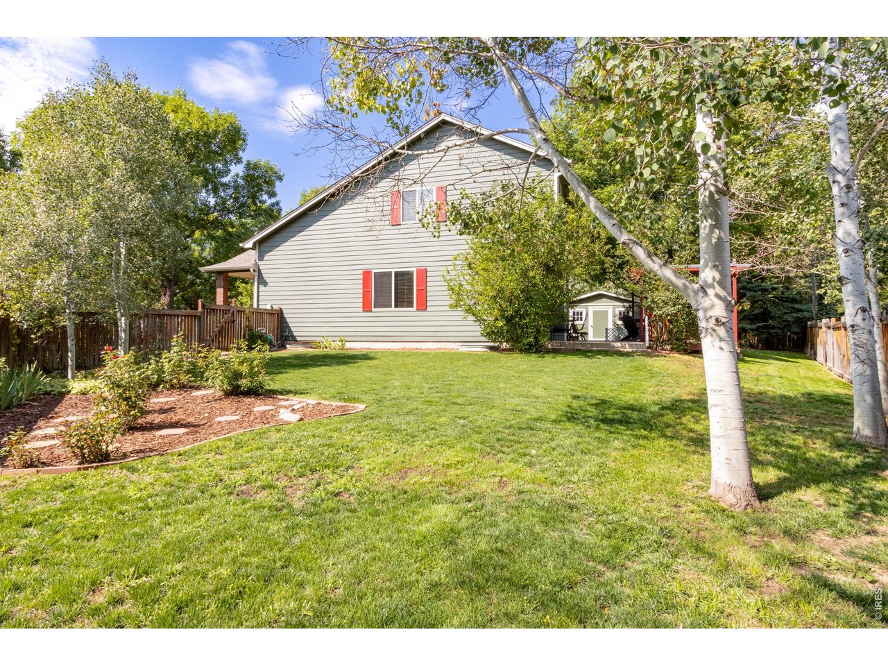 Property Photo 39 Rose garden, green grass and aspen trees.