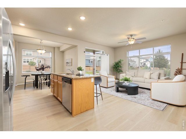 Property Photo 1 Kitchen and Living Area with Abundant Natural Light and Brand New DreamWeaver LVP Flooring Throughout Home