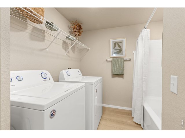 Property Photo 14 Primary Full Bathroom & Laundry Area