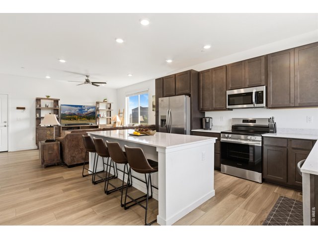 Property Photo 4 Bright, open-concept kitchen and living area with abundant natural light.