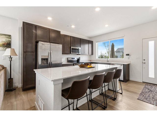 Property Photo 2 "Spacious kitchen featuring a large center island, stainless steel appliances and abundant cabinetry.