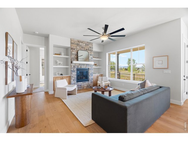 Property Photo 11 Light-filled living room with large windows framing open space and mountain views.