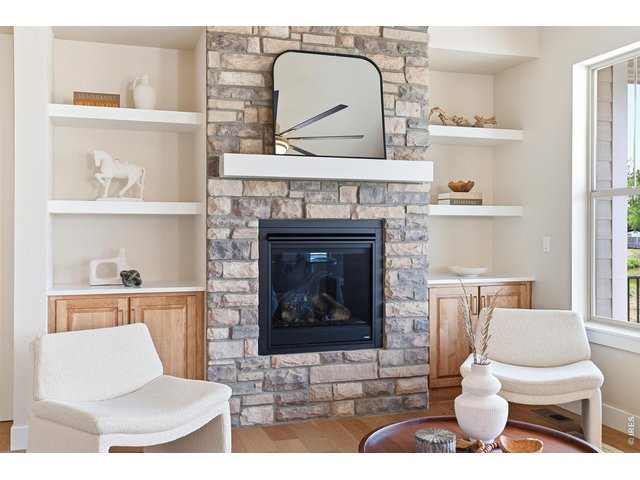 Property Photo 6 Cozy yet refined living space centered around a floor-to-ceiling stone fireplace.
