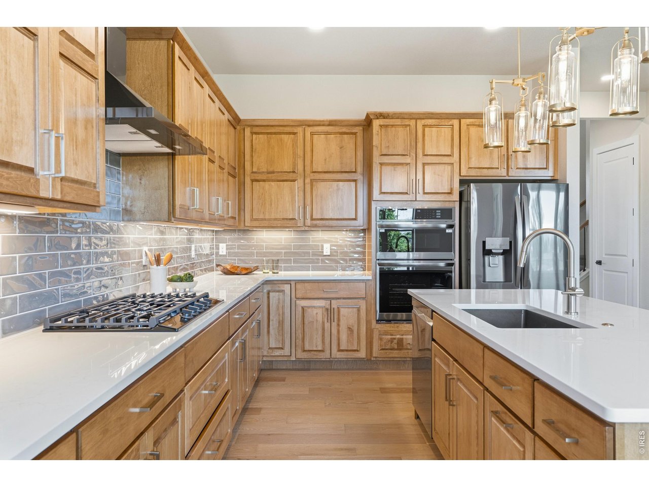 Property Photo 8 Thoughtfully designed kitchen with ample storage and upgraded finishes.