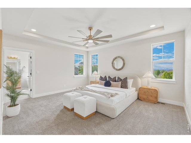 Property Photo 20 Expansive primary suite with tray ceilings, oversized windows, and plenty of room to unwind.