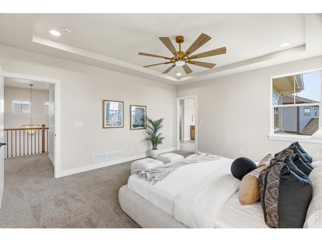 Property Photo 22 A true retreat-this oversized primary bedroom offers comfort, light, and a peaceful atmosphere.
