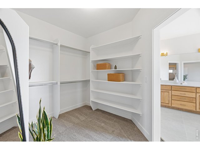 Property Photo 27 Generous walk-in closet with built-in shelving for effortless organization.