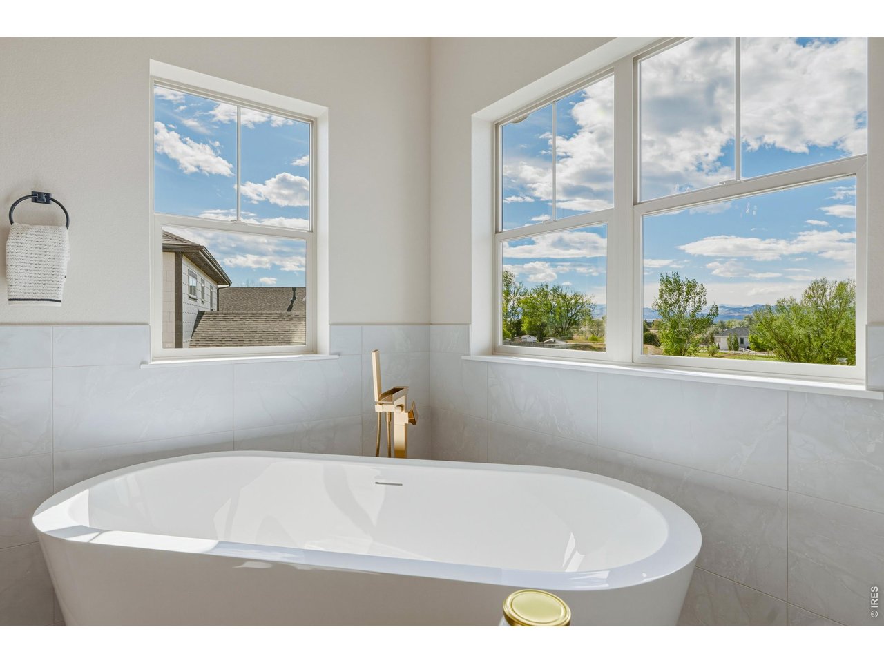 Property Photo 24 Relax and recharge in the soaking tub framed by large windows and mountain views.