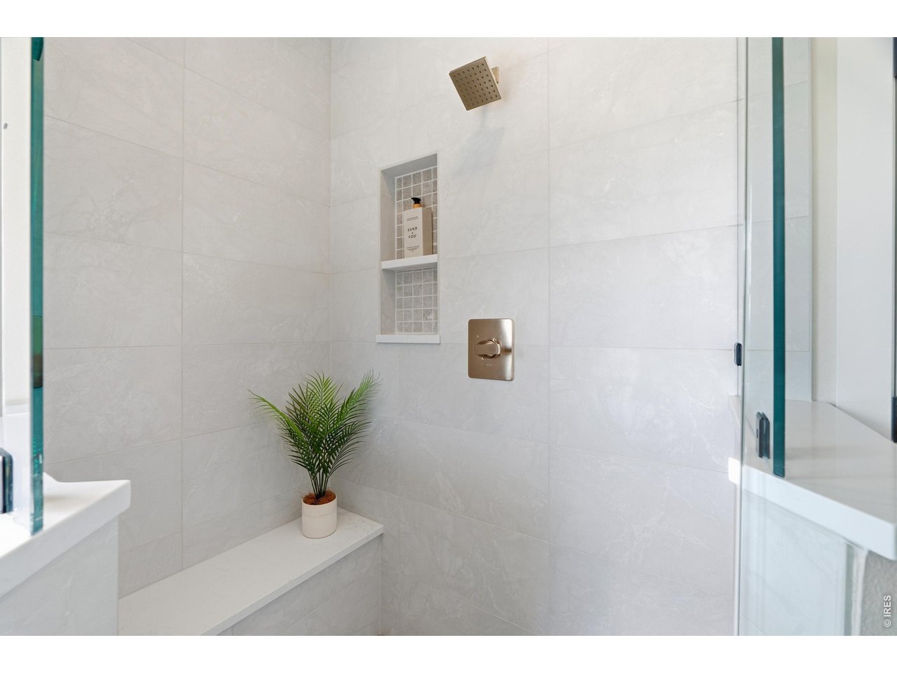 Property Photo 25 Oversized walk-in shower with modern tilework and built-in niche.