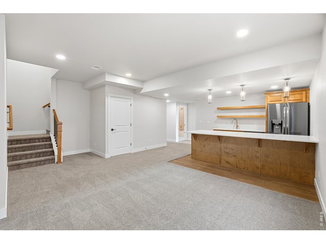 Property Photo 34 Expansive finished basement offering endless flexibility-perfect for movie nights, play space, or hosting friends and family.