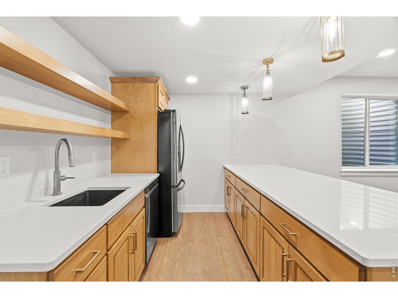 Property Photo 35 Custom wet bar with quartz counters, open shelving, and full-size fridge and dishwasher.