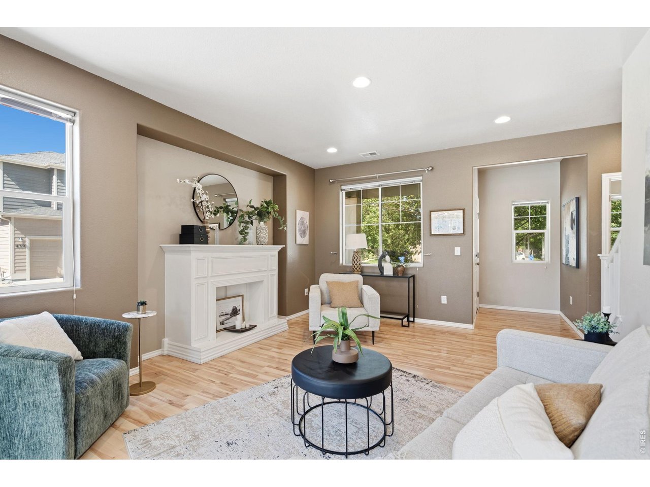Property Photo 11 Living room features recessed lighting, neutral finishes, and custom-built mantle.