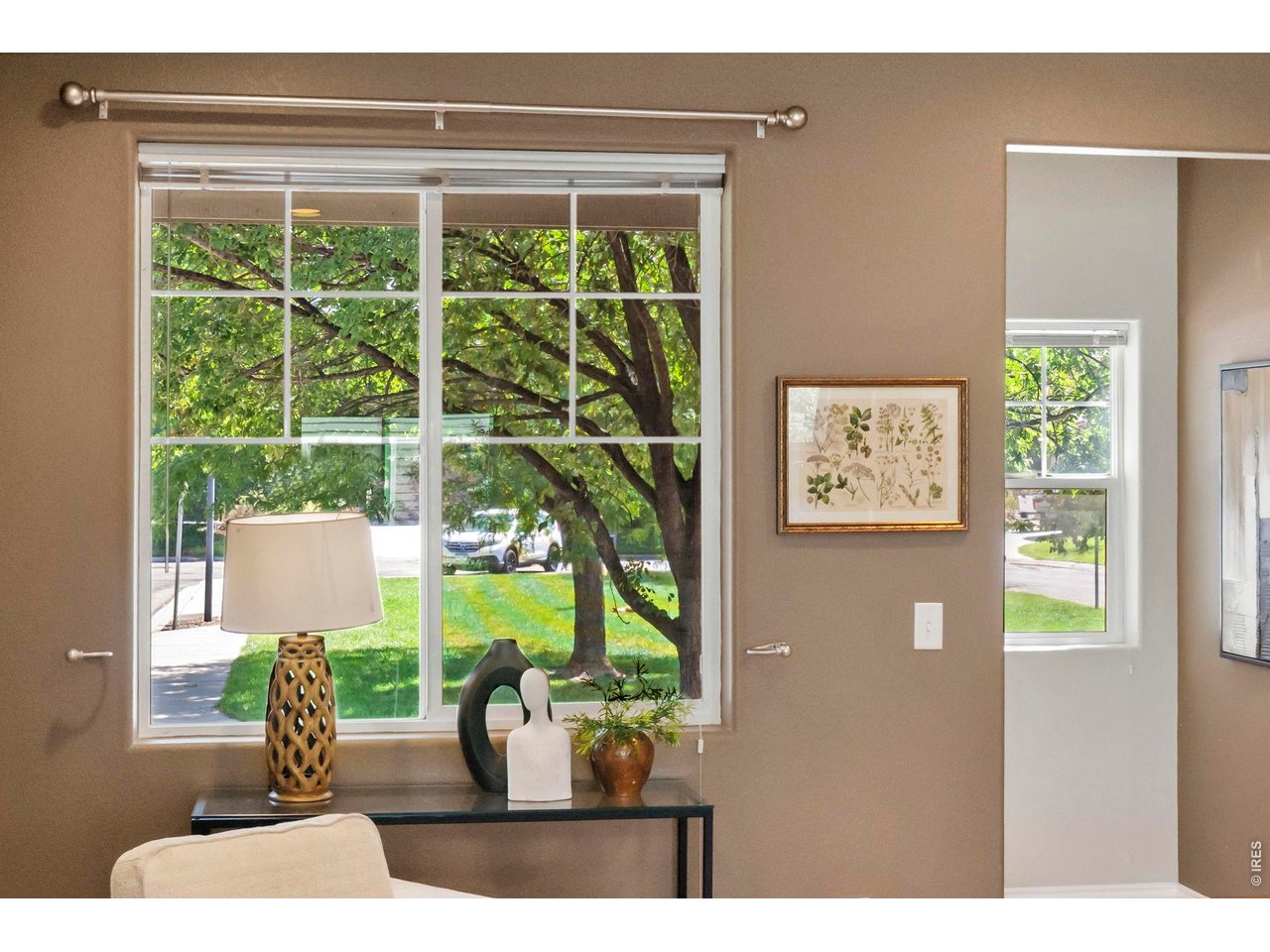 Property Photo 9 Large windows bring in abundant natural light and offer peaceful views of the green space outside.