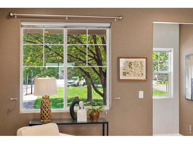 Property Photo 9 Large windows bring in abundant natural light and offer peaceful views of the green space outside.