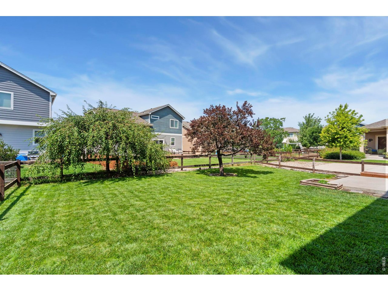 Property Photo 4 Private fenced in backyard with mature trees.