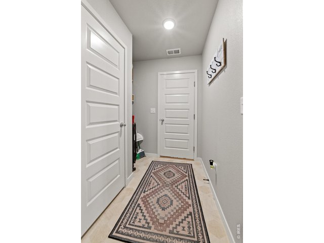 Property Photo 35 Mud room with storage closet leading to garage.