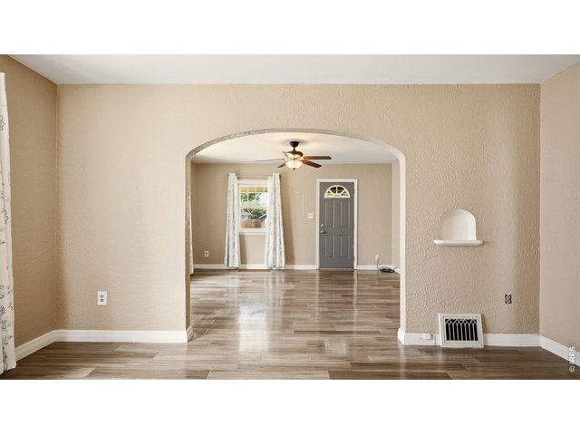 Property Photo 8 Arched opening connects the living and dining areas.