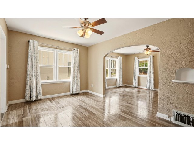 Property Photo 6 Dining area with large windows and easy access to the kitchen.