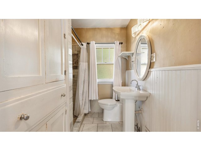Property Photo 14 Main-level bathroom with pedestal sink and tiled shower.