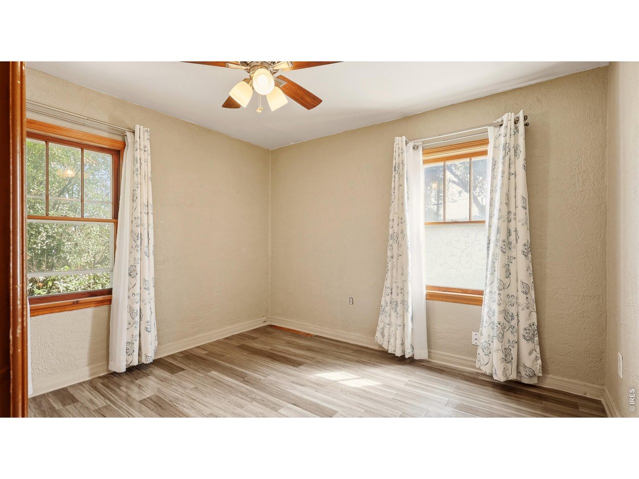 Property Photo 13 Second main-level bedroom with abundant natural light.