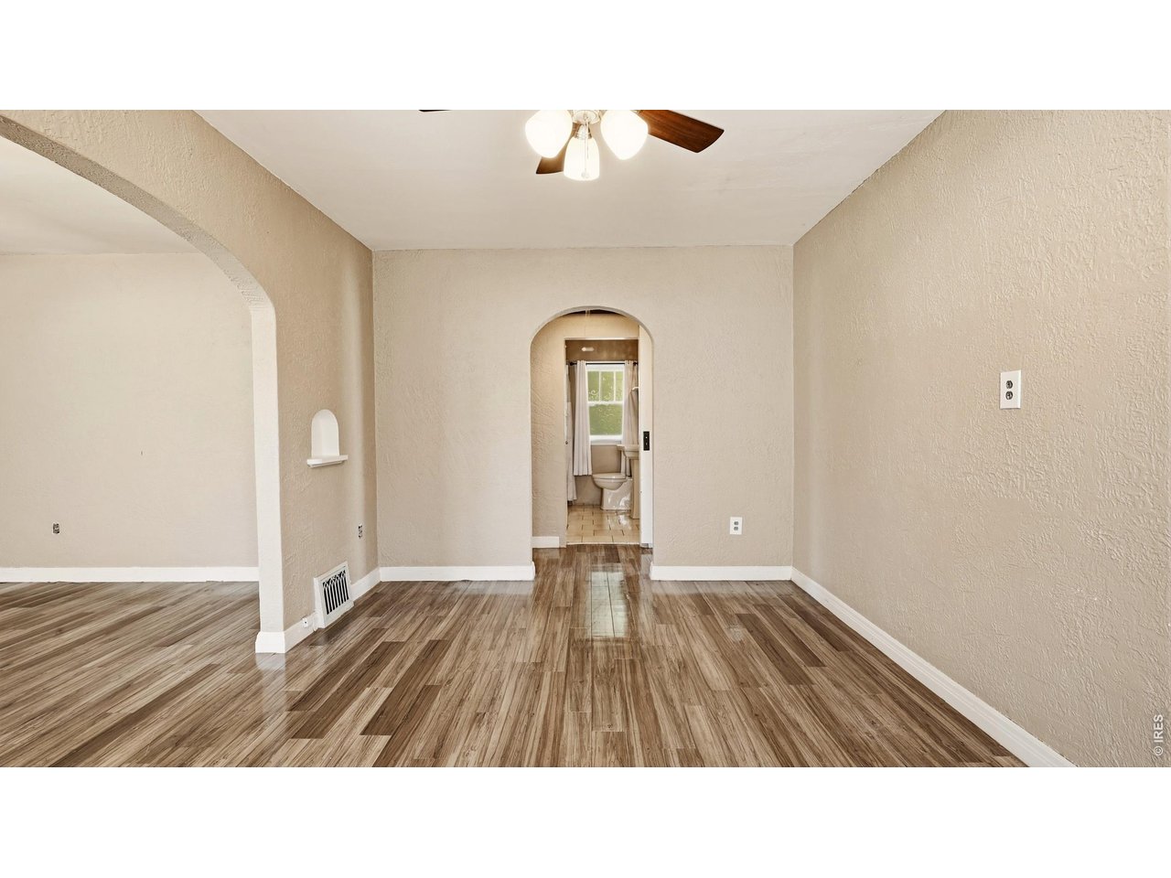 Property Photo 15 Dining area with arched openings and convenient access to the bathroom and bedrooms.