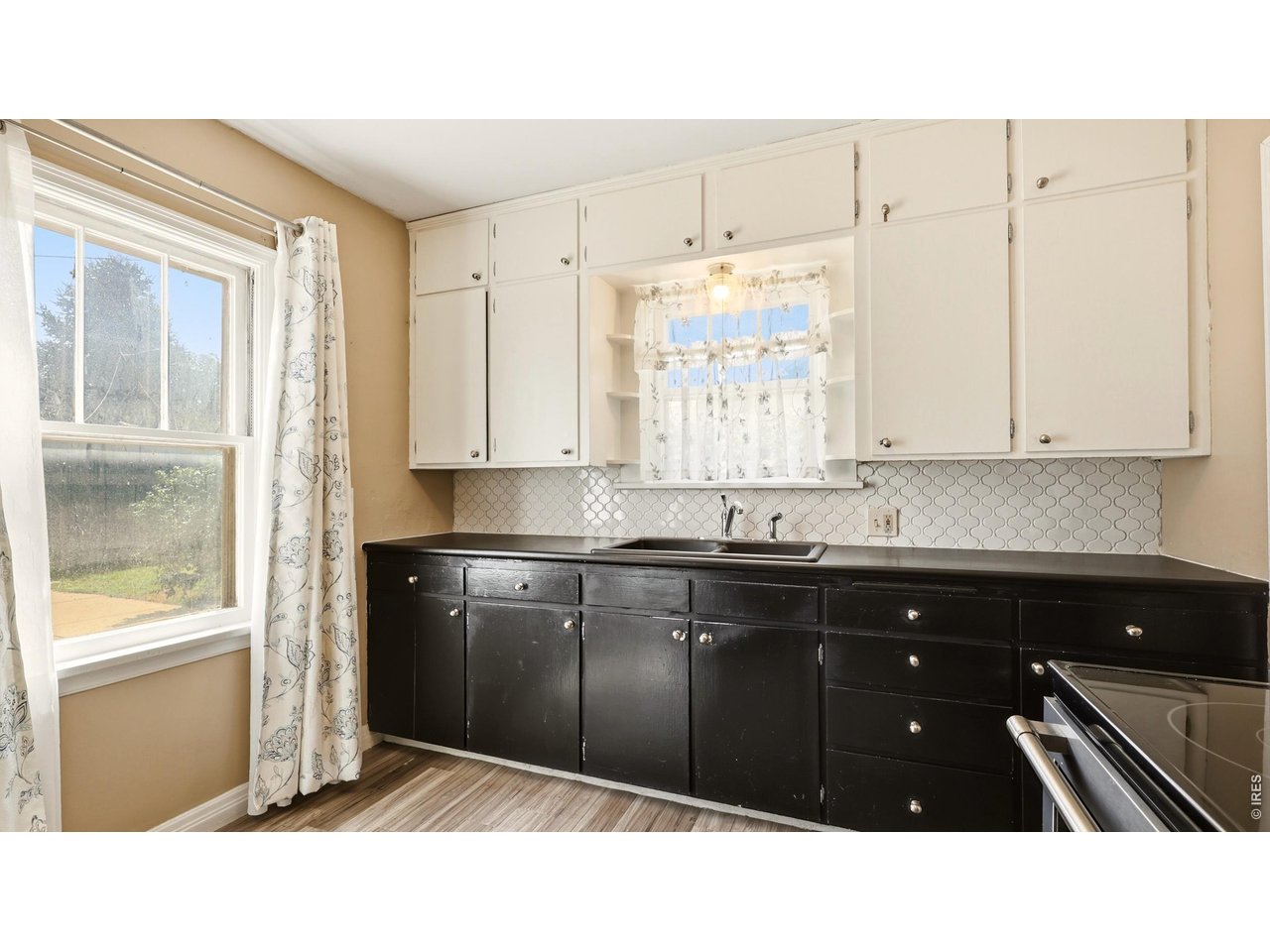 Property Photo 10 Kitchen cabinetry and counter space with natural light from multiple windows.