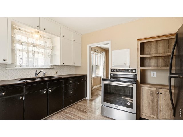 Property Photo 11 Kitchen with additional storage and appliance space.