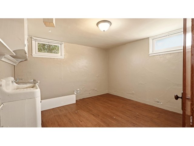 Property Photo 16 Basement flex room with utility sink and storage.