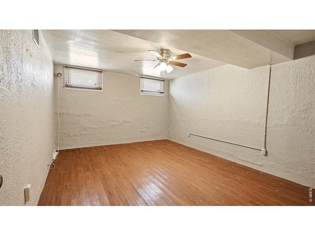 Property Photo 18 Finished basement flex room with LVP flooring.