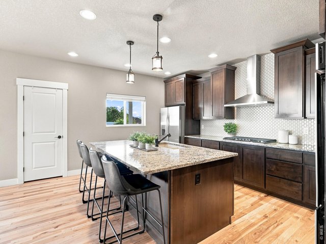 Property Photo 14 Eye-catching tile backsplash adds timeless style to the kitchen. 36" gas range.