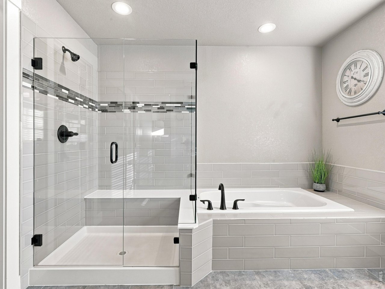 Property Photo 24 Large walk-in shower featuring built-in bench seating. Relax in the oversized soaking tub after a long day.