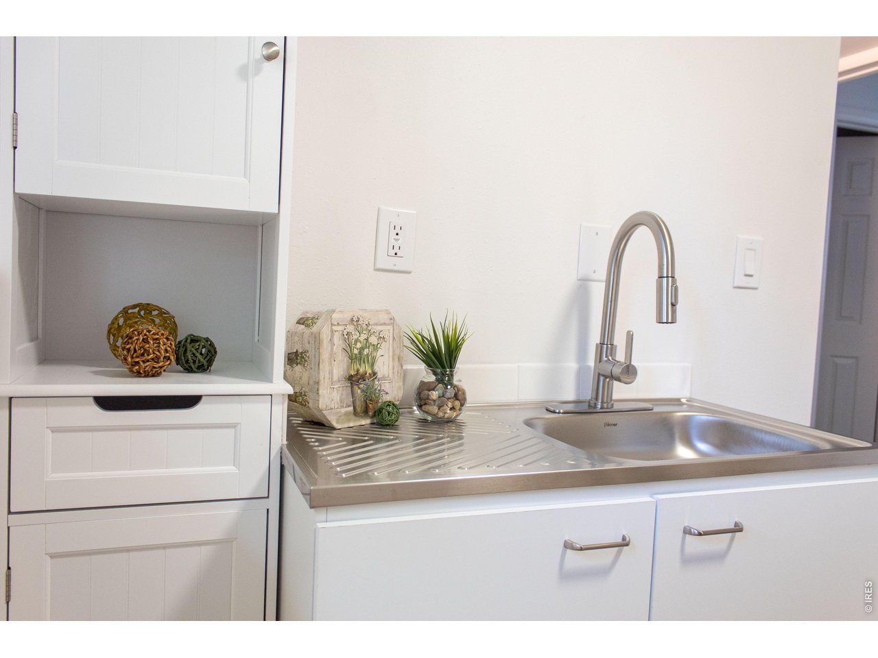 Property Photo 24 Bonus space with sink and cabinetry offers excellent flexibility.