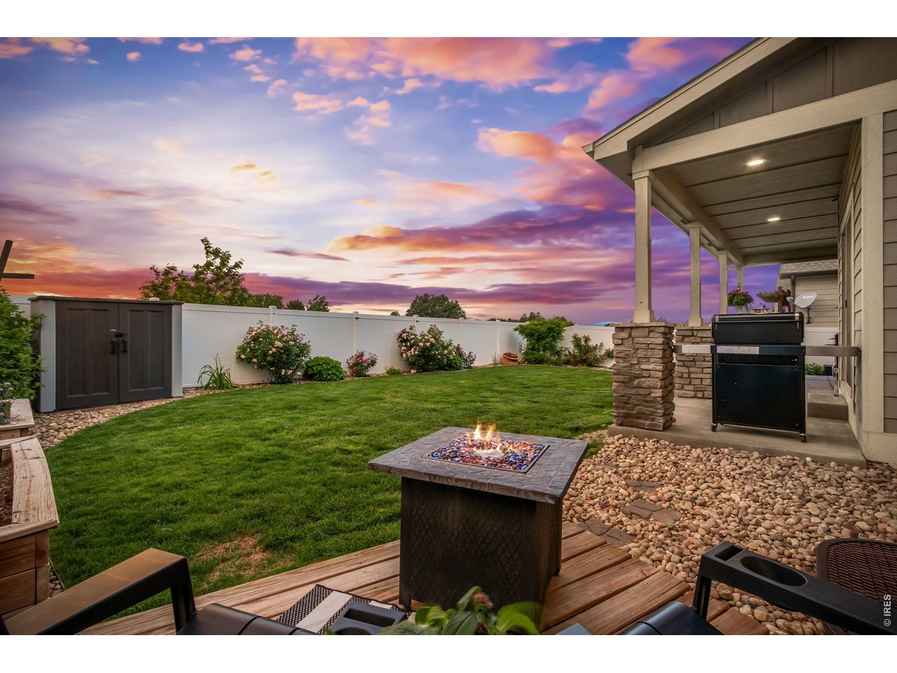 Property Photo 43 Raised garden beds and established rose bushes add charm and color. Another gathering space with fire pit.