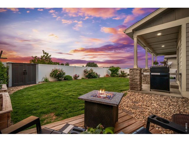 Property Photo 43 Raised garden beds and established rose bushes add charm and color. Another gathering space with fire pit.