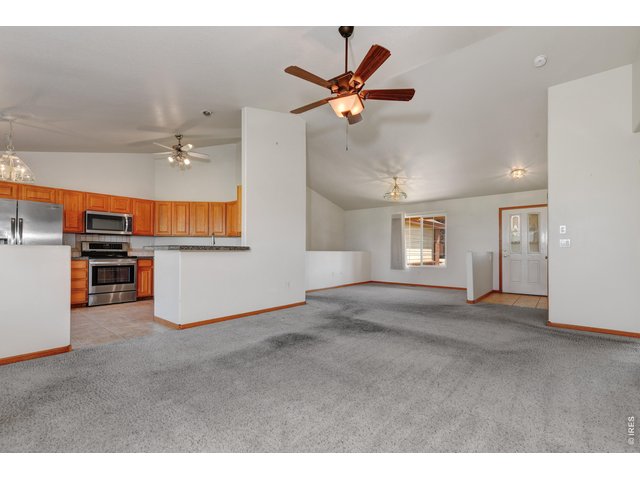 Property Photo 5 Living room- entrance to kitchen - Formal dining area with window to the front yard